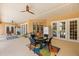 Spacious covered patio with ceiling fans, dining area, and access to outdoor space at 6573 S Magnolia Ave, Ocala, FL 34471