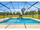 This screened-in private pool has a fun elephant water feature and lounge area at 6573 S Magnolia Ave, Ocala, FL 34471