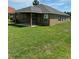 The backyard features a covered patio and a large, well-maintained lawn at 6836 Sw 179Th Court Rd, Dunnellon, FL 34432