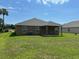 Home's backyard with a covered patio and well maintained lawn at 6836 Sw 179Th Court Rd, Dunnellon, FL 34432