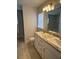 Bathroom with a double sink vanity, granite countertop, and tile flooring at 6836 Sw 179Th Court Rd, Dunnellon, FL 34432