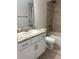 Bathroom featuring a vanity, with granite counters, and a shower with tiled walls at 6836 Sw 179Th Court Rd, Dunnellon, FL 34432