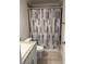 Cozy bathroom featuring a vanity, tile floors, and a decorative shower curtain at 6836 Sw 179Th Court Rd, Dunnellon, FL 34432
