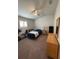 Well-lit bedroom with a ceiling fan, neutral walls, and carpet floors at 6836 Sw 179Th Court Rd, Dunnellon, FL 34432