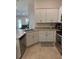 Kitchen with stainless appliances, white cabinets, and views of the living room at 6836 Sw 179Th Court Rd, Dunnellon, FL 34432
