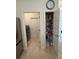 A view from the kitchen of the pantry and laundry room with side-by-side washer and dryer at 6836 Sw 179Th Court Rd, Dunnellon, FL 34432