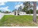 Expansive backyard featuring a well-kept lawn, complemented by a white fence at 7479 Sw 130Th Ln, Ocala, FL 34473