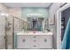 Bathroom with a double sink vanity, a large frameless shower, and a calming color palette at 7479 Sw 130Th Ln, Ocala, FL 34473