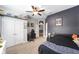 A gamer's bedroom with shelves for collectibles and a door that connects to another room at 7479 Sw 130Th Ln, Ocala, FL 34473