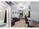 Comfortable bedroom featuring neutral walls, fan, adjacent bathroom and desk space at 7479 Sw 130Th Ln, Ocala, FL 34473