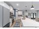 Spacious kitchen featuring stainless steel appliances, white cabinetry, and a center island with a sink at 7479 Sw 130Th Ln, Ocala, FL 34473