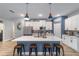 Bright kitchen with a center island, pendant lighting, white cabinets and stainless steel appliances at 7479 Sw 130Th Ln, Ocala, FL 34473