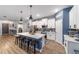 Modern kitchen features a large center island with seating and stylish pendant lighting at 7479 Sw 130Th Ln, Ocala, FL 34473