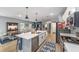 Open layout with view of the kitchen, living room, and dining area, all featuring wood flooring at 7479 Sw 130Th Ln, Ocala, FL 34473