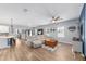Open living room features luxury vinyl flooring, a ceiling fan, and ample natural light at 7479 Sw 130Th Ln, Ocala, FL 34473