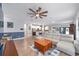Open concept living space with wood flooring that leads to the dining and kitchen areas at 7479 Sw 130Th Ln, Ocala, FL 34473