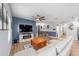 Spacious living room with modern ceiling fan, and a large mounted television above an entertainment center at 7479 Sw 130Th Ln, Ocala, FL 34473