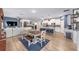 Open-concept living and dining area features a spacious layout, modern lighting, and durable wood flooring at 7479 Sw 130Th Ln, Ocala, FL 34473