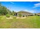 Well-maintained backyard with lush green lawn, manicured landscaping, and mature trees at 7917 Sw 85Th Loop, Ocala, FL 34476