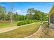 Beautiful backyard featuring lush greenery, a manicured lawn, and decorative landscaping at 7917 Sw 85Th Loop, Ocala, FL 34476