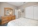Comfortable bedroom with a dresser, closet, and neutral color scheme creating a relaxing retreat at 7917 Sw 85Th Loop, Ocala, FL 34476