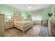 Bright bedroom with light green walls, large windows, and a tranquil atmosphere perfect for relaxation at 7917 Sw 85Th Loop, Ocala, FL 34476