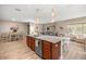 Open concept kitchen with granite counters, modern appliances, and seamless flow to the living and dining areas at 7917 Sw 85Th Loop, Ocala, FL 34476