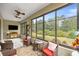 Relaxing lanai with beautiful views of a green lawn, comfortable seating, and dual ceiling fans at 7917 Sw 85Th Loop, Ocala, FL 34476