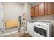 Well-equipped laundry room with modern washer and dryer, cabinet storage, and efficient layout at 7917 Sw 85Th Loop, Ocala, FL 34476
