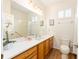 Bathroom features wood cabinets, laminate floors, white countertops, and white walls at 8303 Sw 82Nd Cir, Ocala, FL 34481