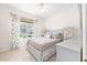 Comfortable bedroom with a ceiling fan, large window, and neutral decor at 8303 Sw 82Nd Cir, Ocala, FL 34481