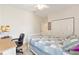 Bedroom with white walls, white trim, chair, desk, and an area rug at 8303 Sw 82Nd Cir, Ocala, FL 34481