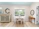 Bright dining room features white table with seating for four, decor, natural light, and wood-look flooring at 8303 Sw 82Nd Cir, Ocala, FL 34481