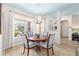 Bright dining room features a round wood table, four upholstered chairs, and a large window at 8303 Sw 82Nd Cir, Ocala, FL 34481
