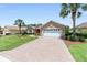 Charming home with a brick driveway, well-maintained landscaping, and an inviting two-car garage at 8303 Sw 82Nd Cir, Ocala, FL 34481