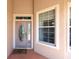 Close-up of front door showcasing decorative glass, sidelights, and a welcoming entrance mat at 8303 Sw 82Nd Cir, Ocala, FL 34481