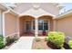 Inviting front porch with decorative columns, a stylish front door, and well-maintained landscaping at 8303 Sw 82Nd Cir, Ocala, FL 34481
