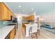 Open kitchen boasts bright wood cabinets, modern appliances, quartz countertops, and island seating at 8303 Sw 82Nd Cir, Ocala, FL 34481