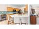 Open kitchen features bright wood cabinets, stainless appliances, and a quartz countertop island at 8303 Sw 82Nd Cir, Ocala, FL 34481