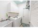 Bright laundry room with white cabinets, modern washer/dryer and basin for added convenience at 8303 Sw 82Nd Cir, Ocala, FL 34481