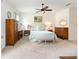 Spacious main bedroom features a ceiling fan, upholstered headboard, and neutral-toned decor at 8303 Sw 82Nd Cir, Ocala, FL 34481