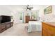 This spacious main bedroom features large windows, carpet, and an ensuite bath at 8303 Sw 82Nd Cir, Ocala, FL 34481
