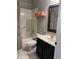 Bathroom featuring a tub, vanity with black cabinets, and framed mirror at 8447 Sw 82Nd Loop, Ocala, FL 34481