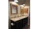 Bathroom featuring double sinks, granite countertops, and updated lighting at 8447 Sw 82Nd Loop, Ocala, FL 34481