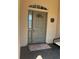Elegant front door with decorative glass, sidelight, and transom window, enhanced by a stylish welcome mat at 8447 Sw 82Nd Loop, Ocala, FL 34481