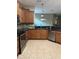 Beautiful kitchen featuring dark granite countertops, stainless steel appliances, and a neutral tile backsplash at 8447 Sw 82Nd Loop, Ocala, FL 34481