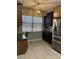 Inviting kitchen nook with stainless steel appliances, dark cabinets, and a window with natural light at 8447 Sw 82Nd Loop, Ocala, FL 34481