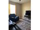 Cozy living room with a plush recliner and a media center with a flat-screen TV at 8447 Sw 82Nd Loop, Ocala, FL 34481