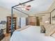 Comfortable bedroom featuring a four-poster bed, barn door, and built in shelving at 8447 Sw 82Nd Loop, Ocala, FL 34481