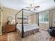 Comfortable bedroom featuring a four-poster bed, an area rug, and natural light at 8447 Sw 82Nd Loop, Ocala, FL 34481